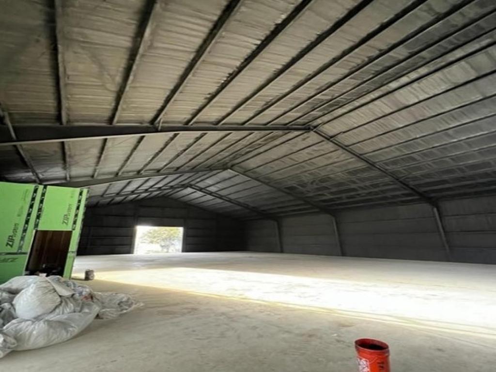 Completed spray foam insulation across a large metal-building roof assembly
